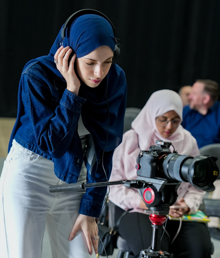 Rahma monitoring sound beside the camera